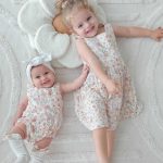 bebe fille dans sa barboteuse bebe dos nu et sa soeur dans sa robe du nu. Double gaze fleurie